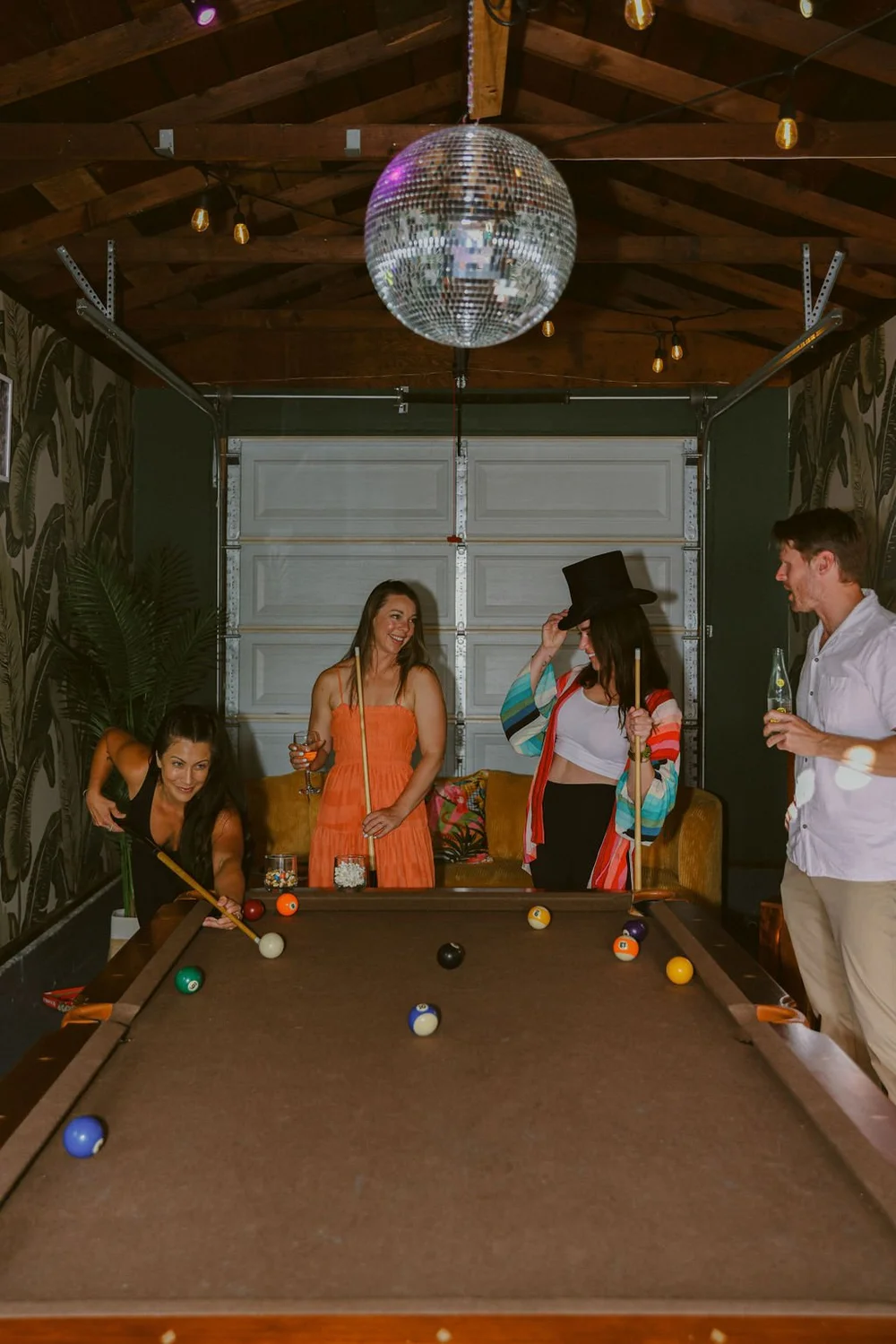 Friends playing pool in the game room at Palm Parkside