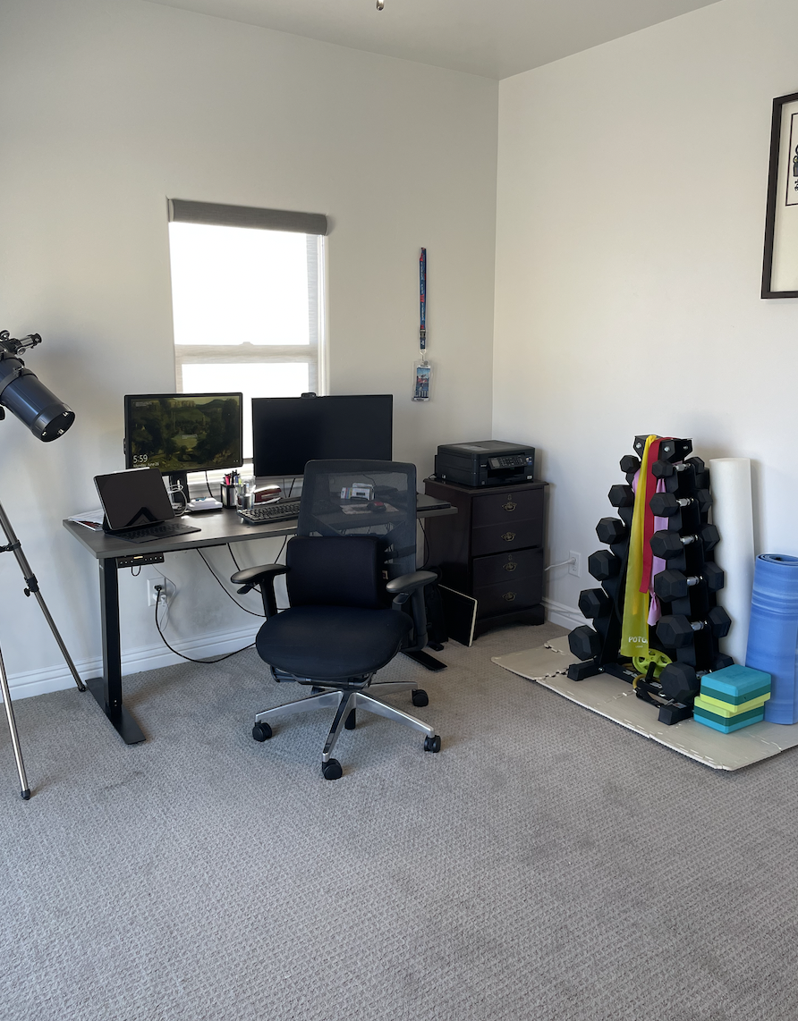 Before: Home office with desks and weights at Coastal Palm in Pacific Beach