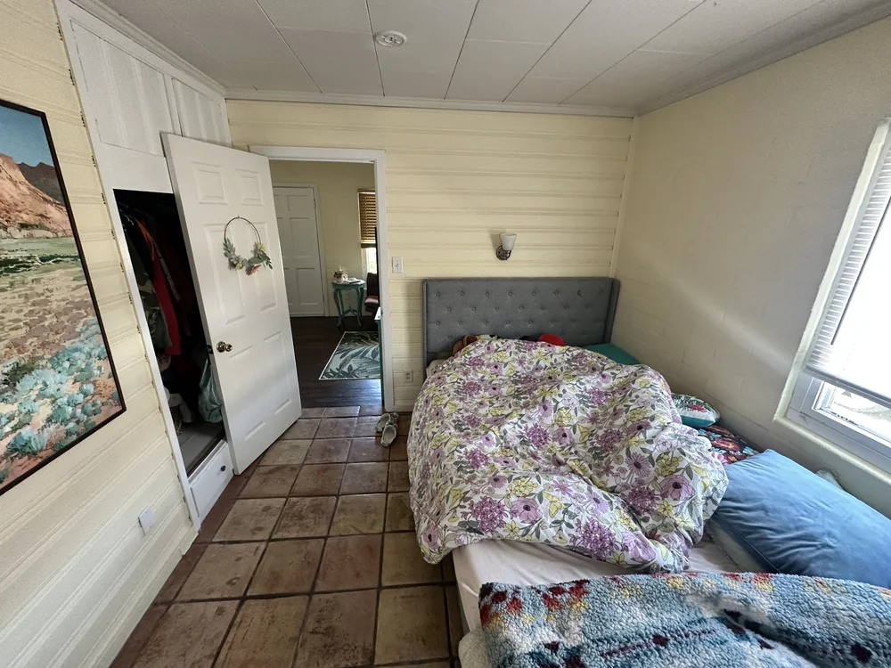Before: Bedroom with a tile floor at Clementine B in Oceanside