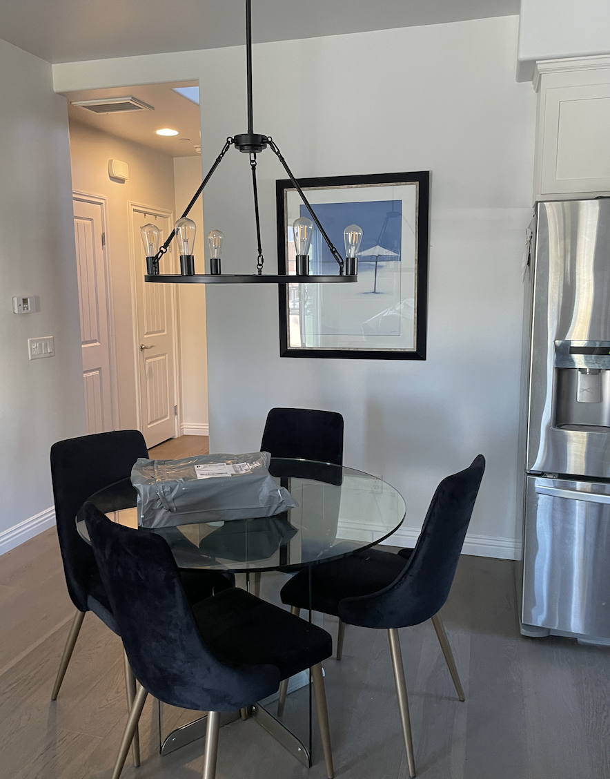Before: Dining area with a glass table at Coastal Palm in Pacific Beach