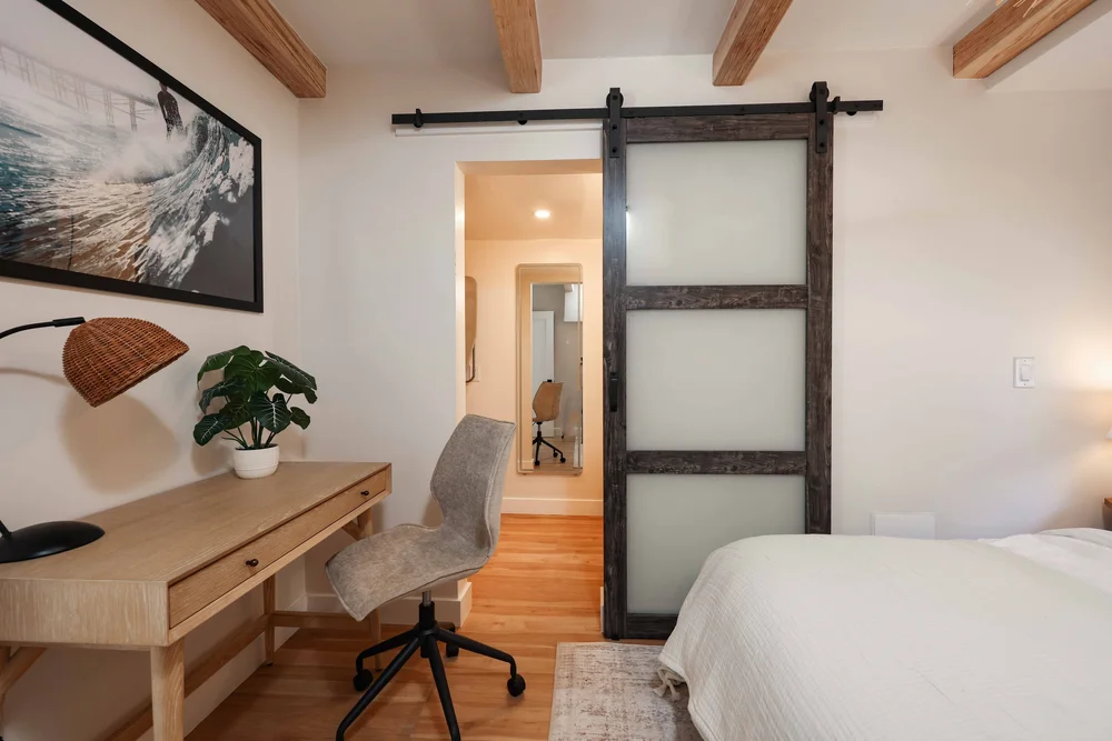 The desk beside the sliding barn door in Unit Two at The Swell, Oceanside