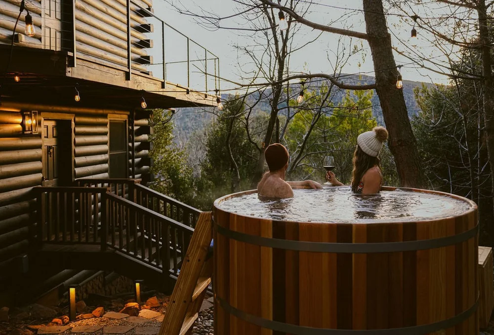 Dark Moon Chalet cabin rental near Julian California, the cedar hot tub at dusk under string lights
