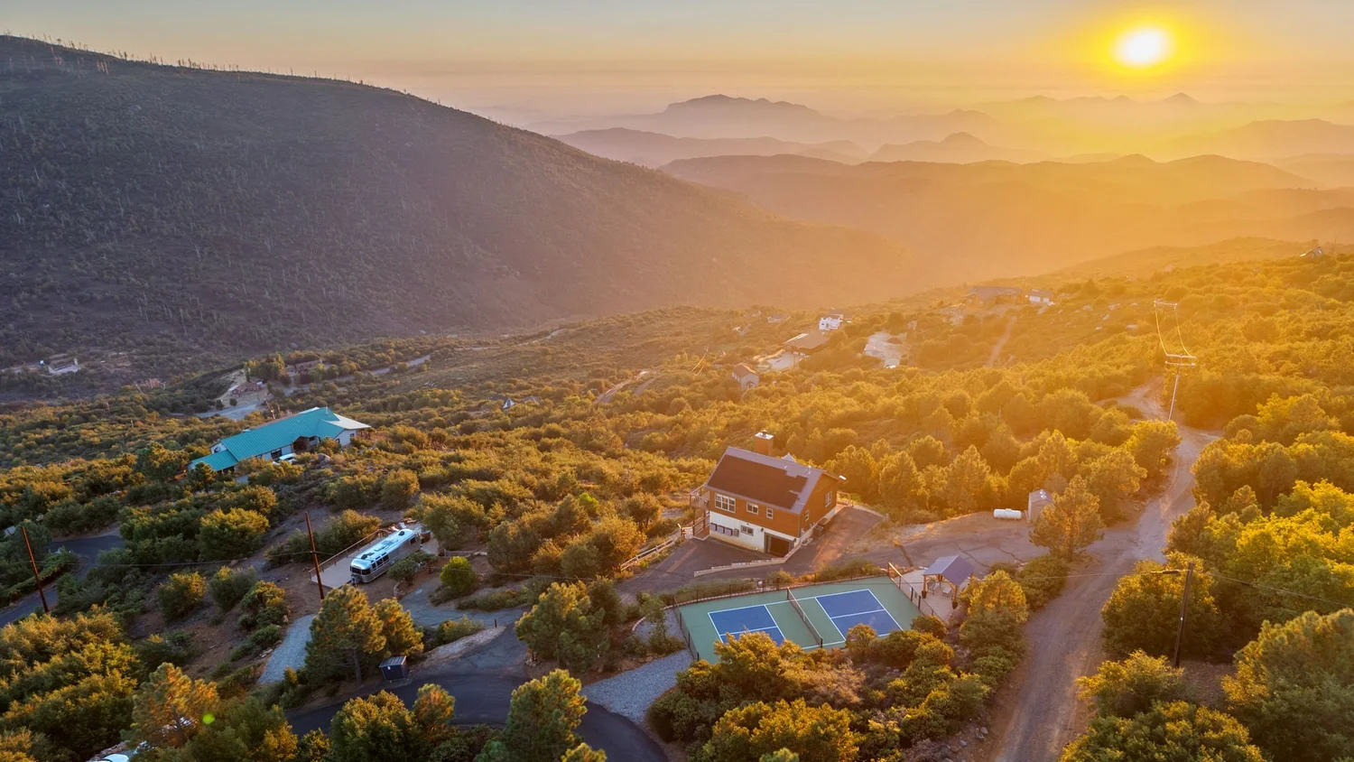 Overhead view of Wild Moon Ranch cabin and private pickleball court on the mountaintop