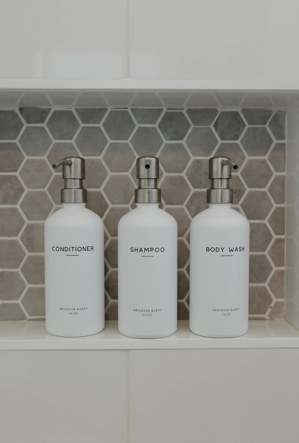 Shampoo, conditioner and body wash on the shelf in The Sandbar bathroom