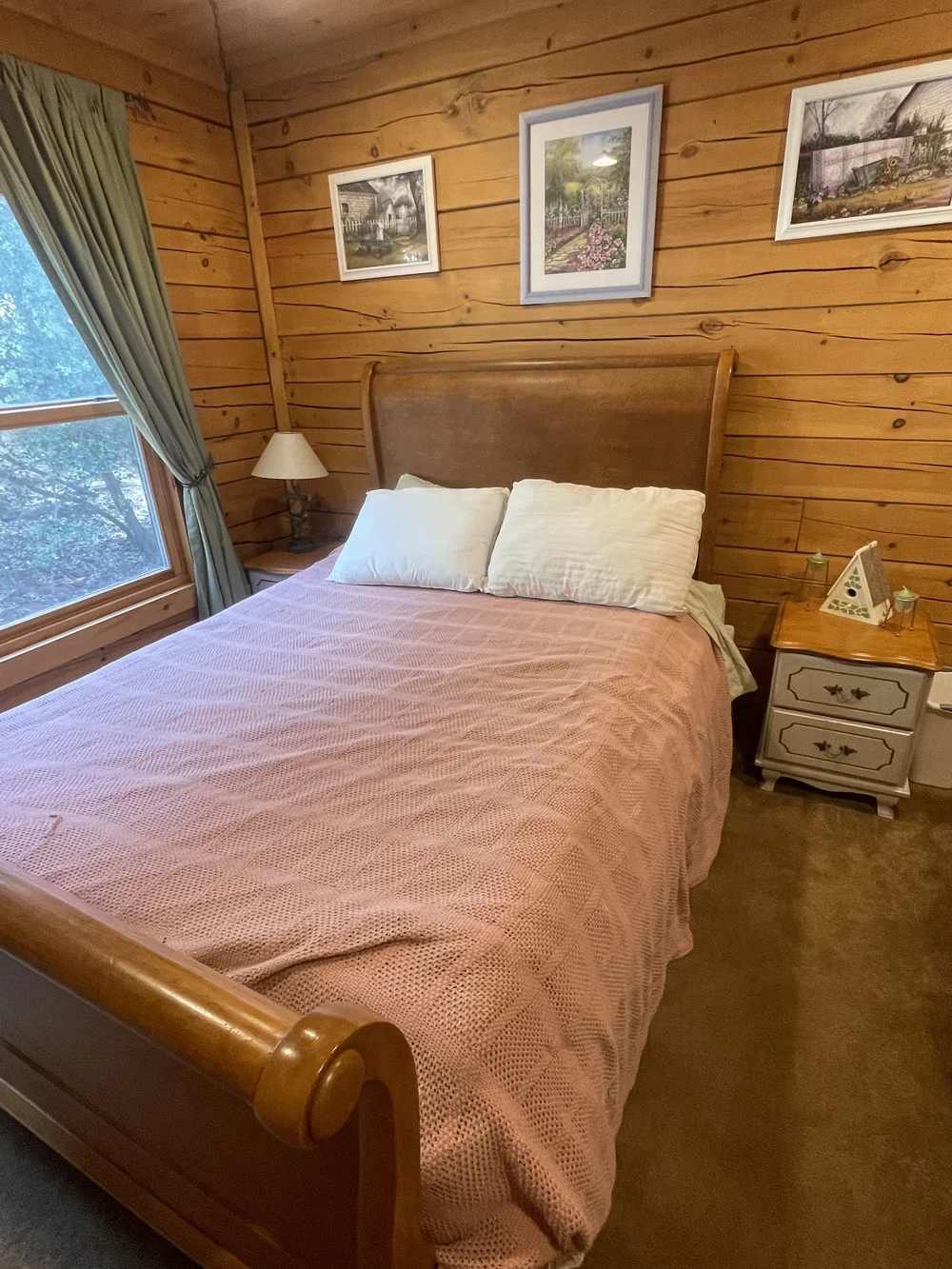 Before: Bedroom with a pink bedspread and a sleigh bed at Dark Moon Chalet in Julian
