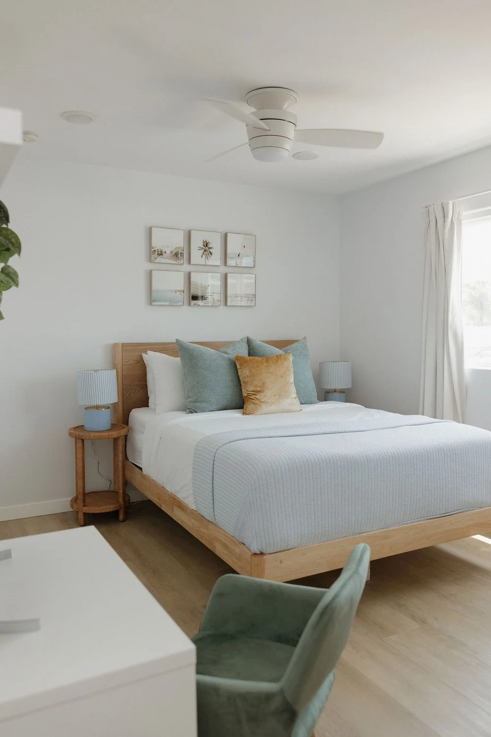 The second bedroom in The East Cove with a light wood bed and blue and gold pillows