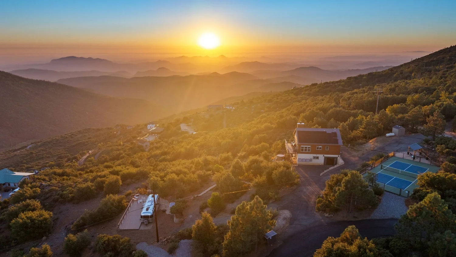 Wild Moon Ranch + Restore Outpost near Julian at sunset, with the private pickleball court, cabin and Airstream on two secluded acres
