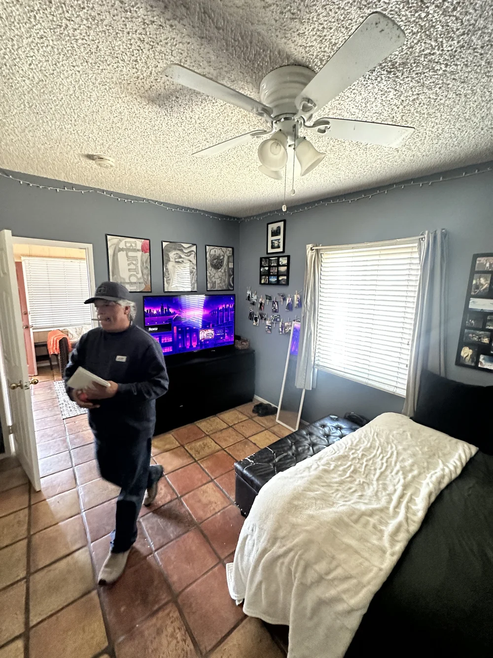 Before: Bedroom with gray walls and a TV at Clementine C in Oceanside