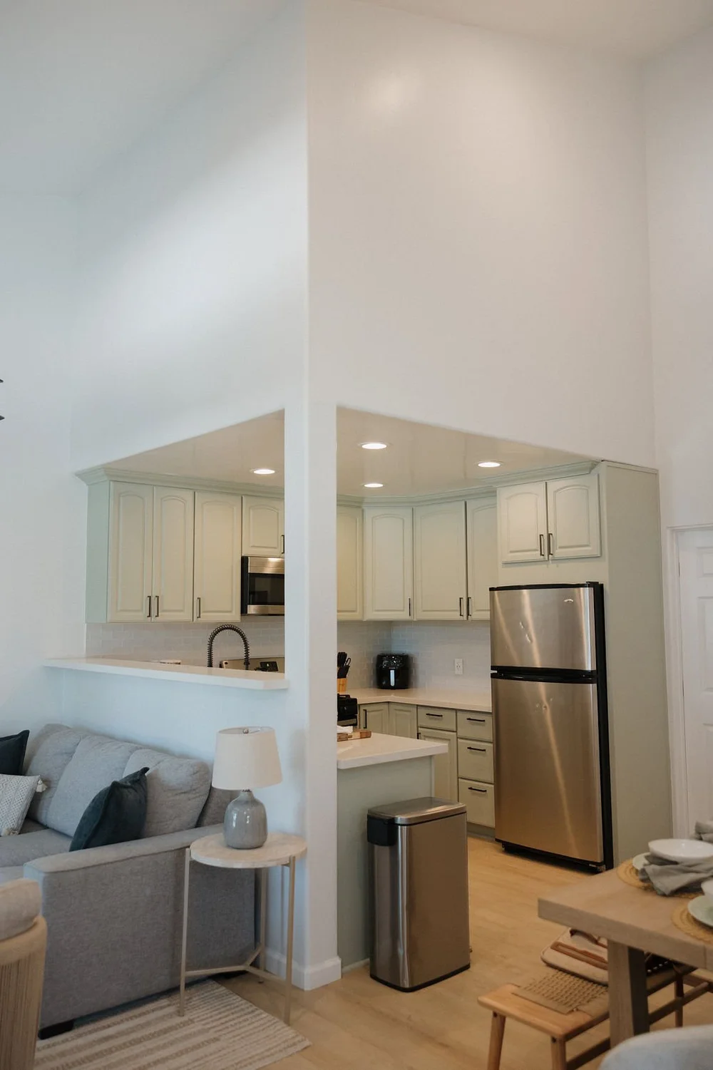 The living room and white kitchen in The West Cove townhome