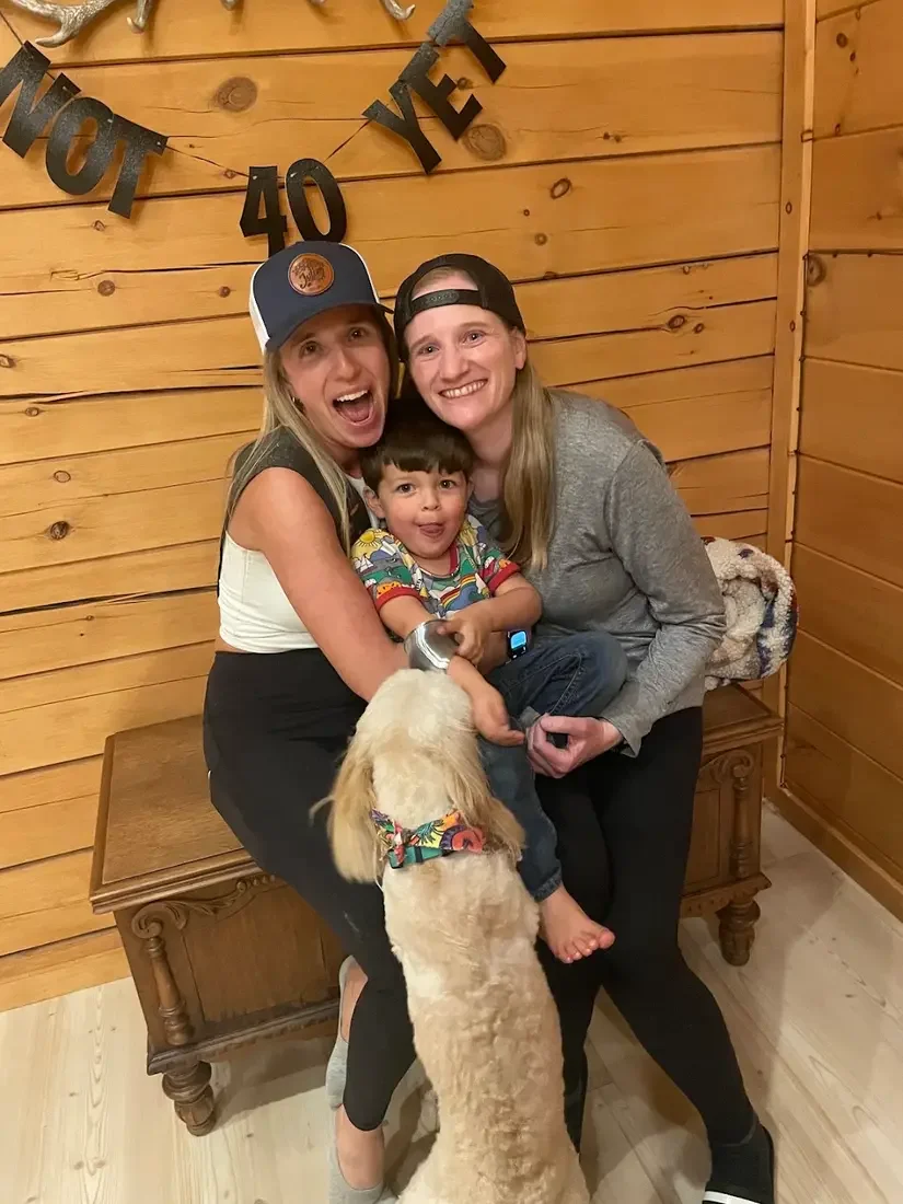 Guest photo: a family celebrating a birthday with their dog inside the cabin