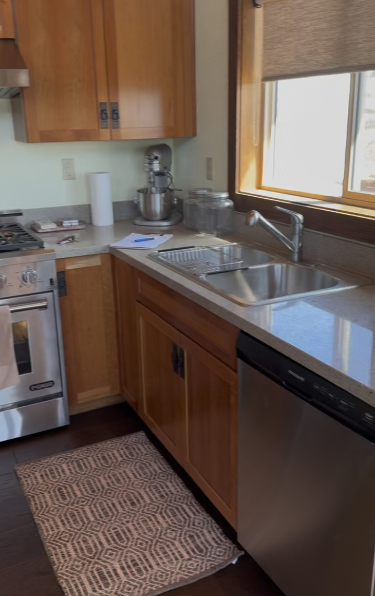 Before: L-shaped kitchen with oak cabinets and granite counters