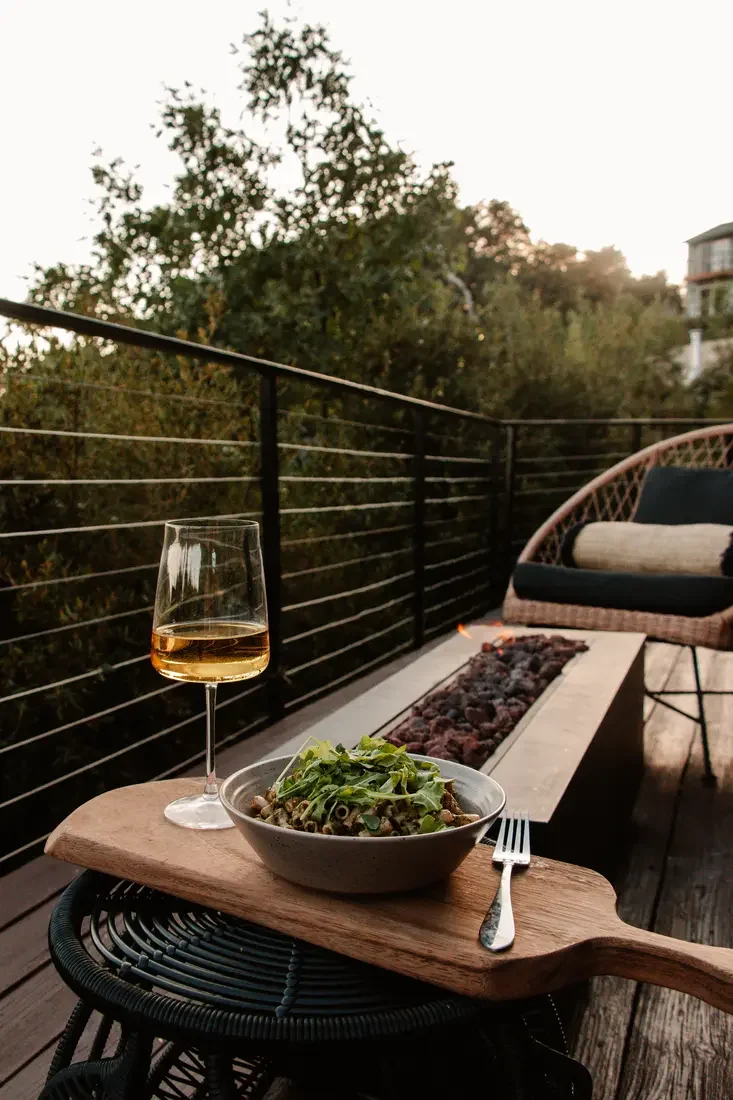 Guest photo: a glass of wine and dinner on the deck at dusk