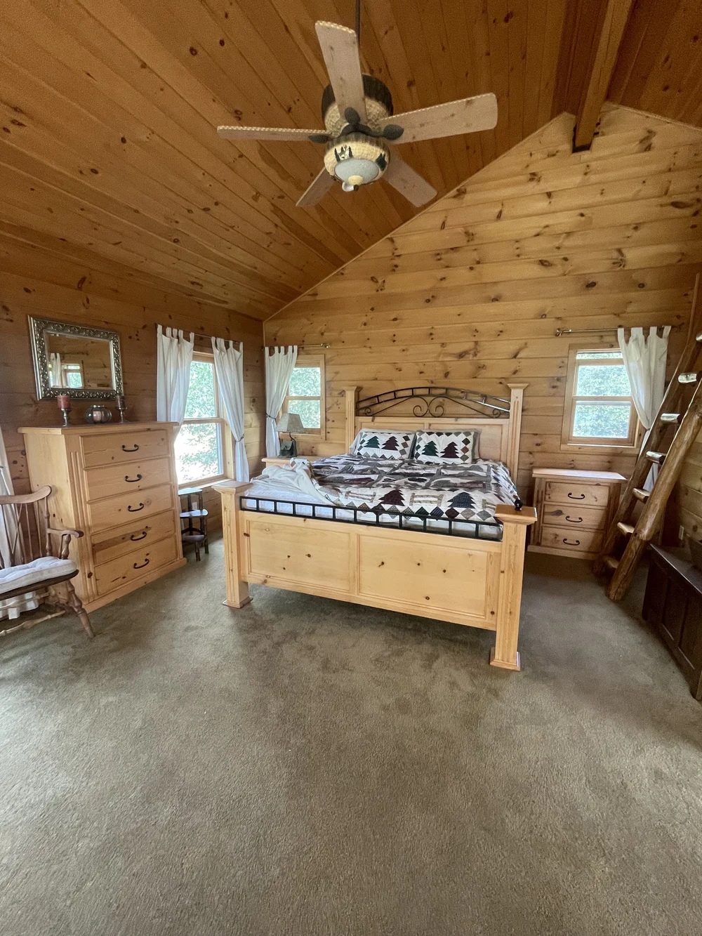 Before: Bedroom with a pine bed and a ceiling fan at Dark Moon Chalet in Julian