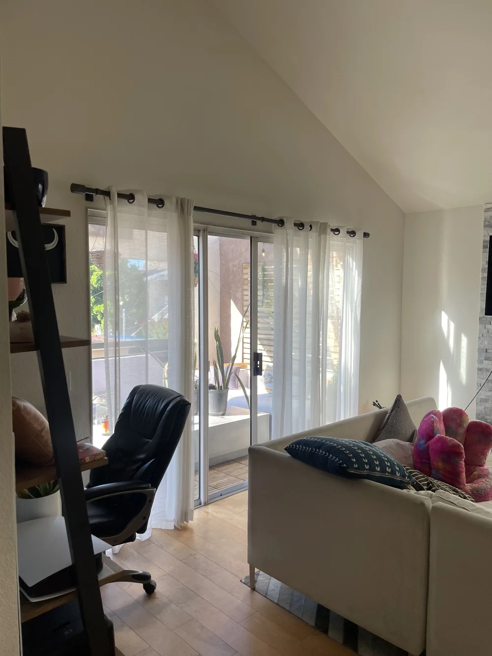 Before: Living room with a sectional at Velvet Surf in Pacific Beach