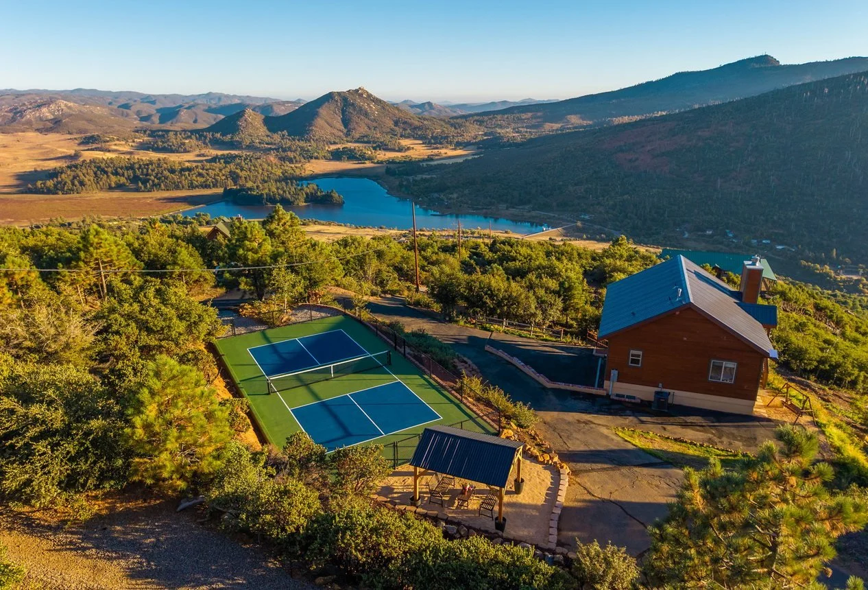 Wild Moon Ranch above Lake Cuyamaca near Julian, a mountain cabin on two acres with a private pickleball court and pine covered ridgelines beyond