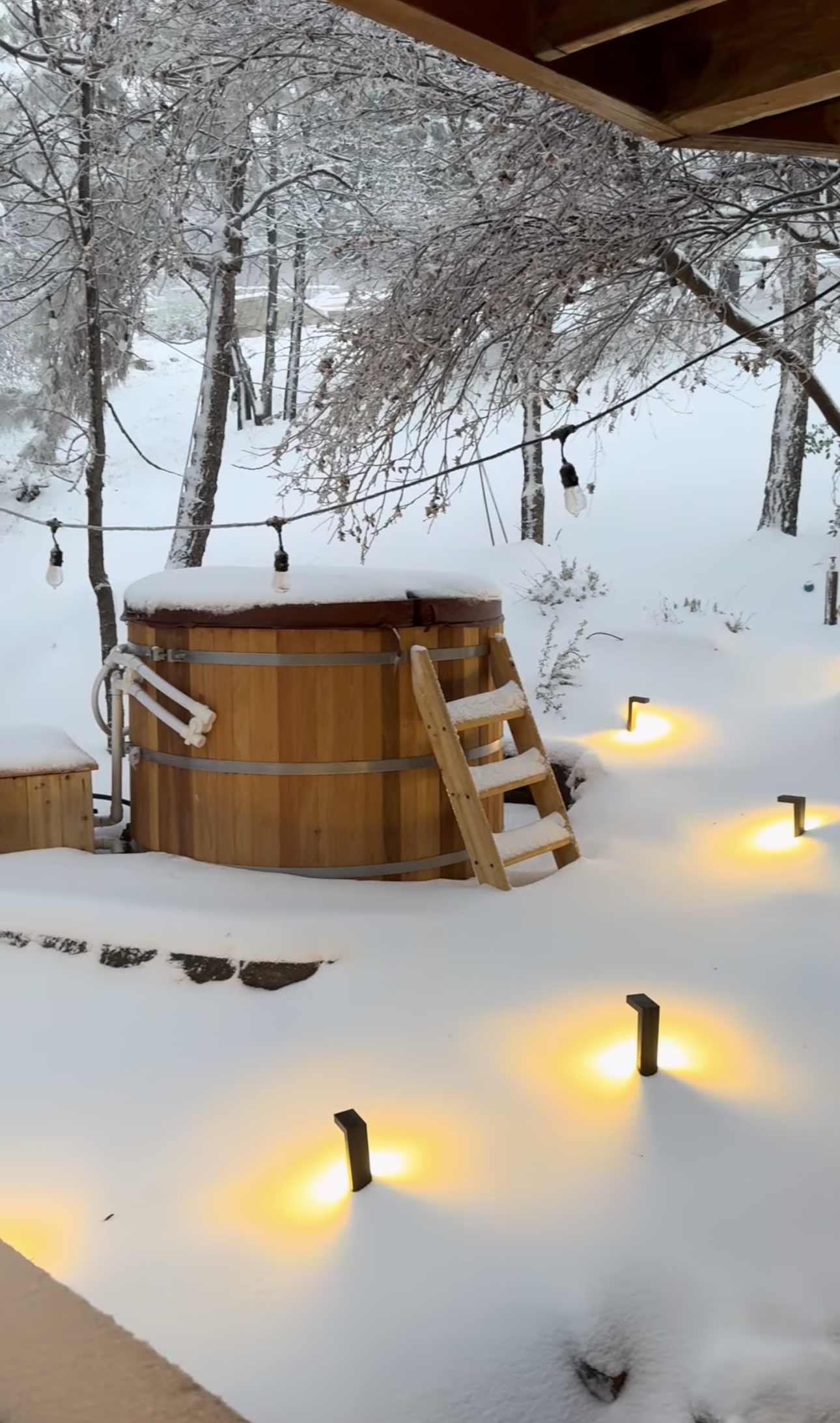 Guest photo: the cedar hot tub in the snow at Dark Moon Chalet