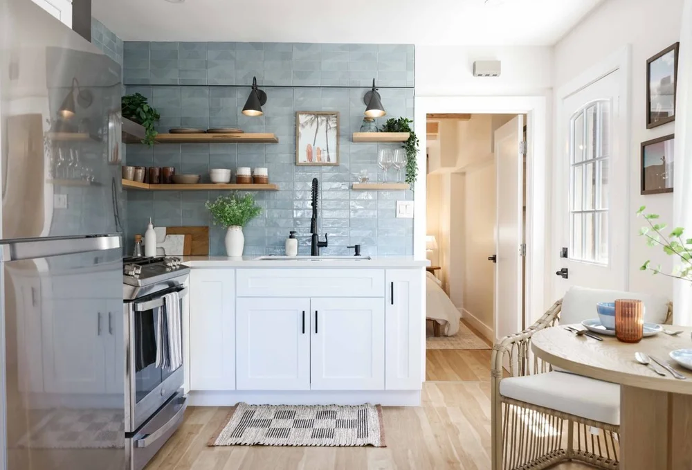The Swell Unit Two in Oceanside, a kitchen with blue zellige tile and a rattan dining set, set up for monthly stays
