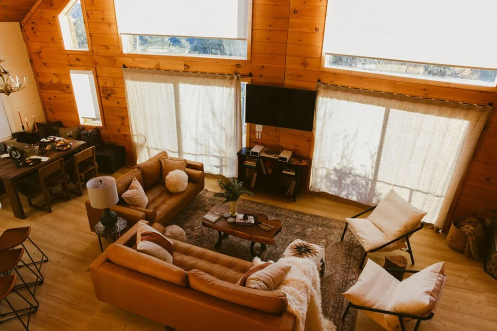 Soaring A-frame windows and mountain views in the great room — Julian California log cabin
