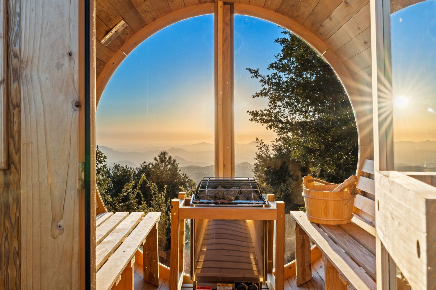 View from the Airstream doorway onto the Restore Outpost deck at sunset