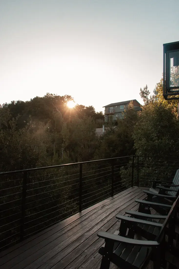 Guest photo: sunset over the pines from the wraparound deck