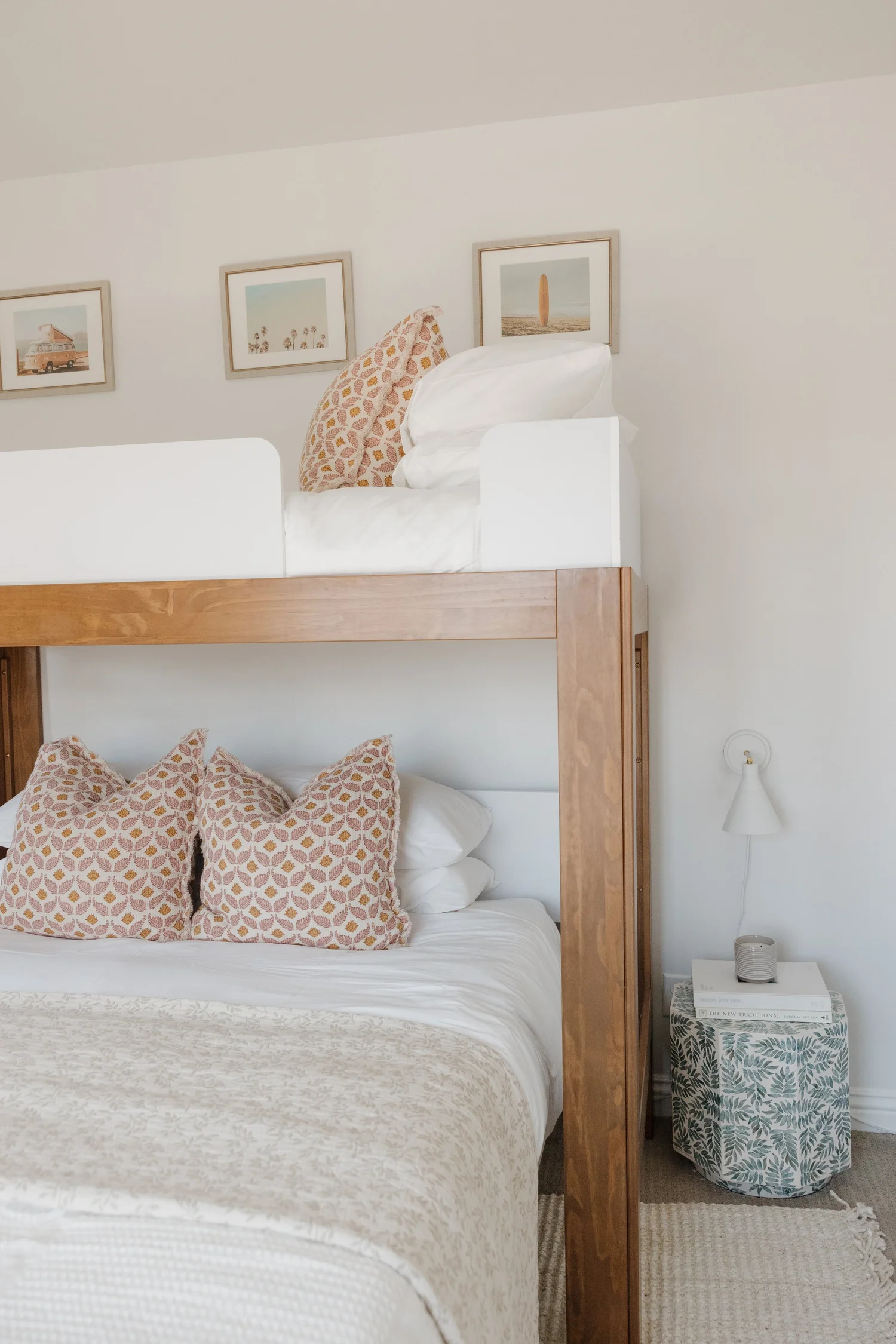 Bunk room with a wood loft bed and blush patterned pillows at Coastal Palm in Pacific Beach, designed by Salt and Sky Lodging Co.