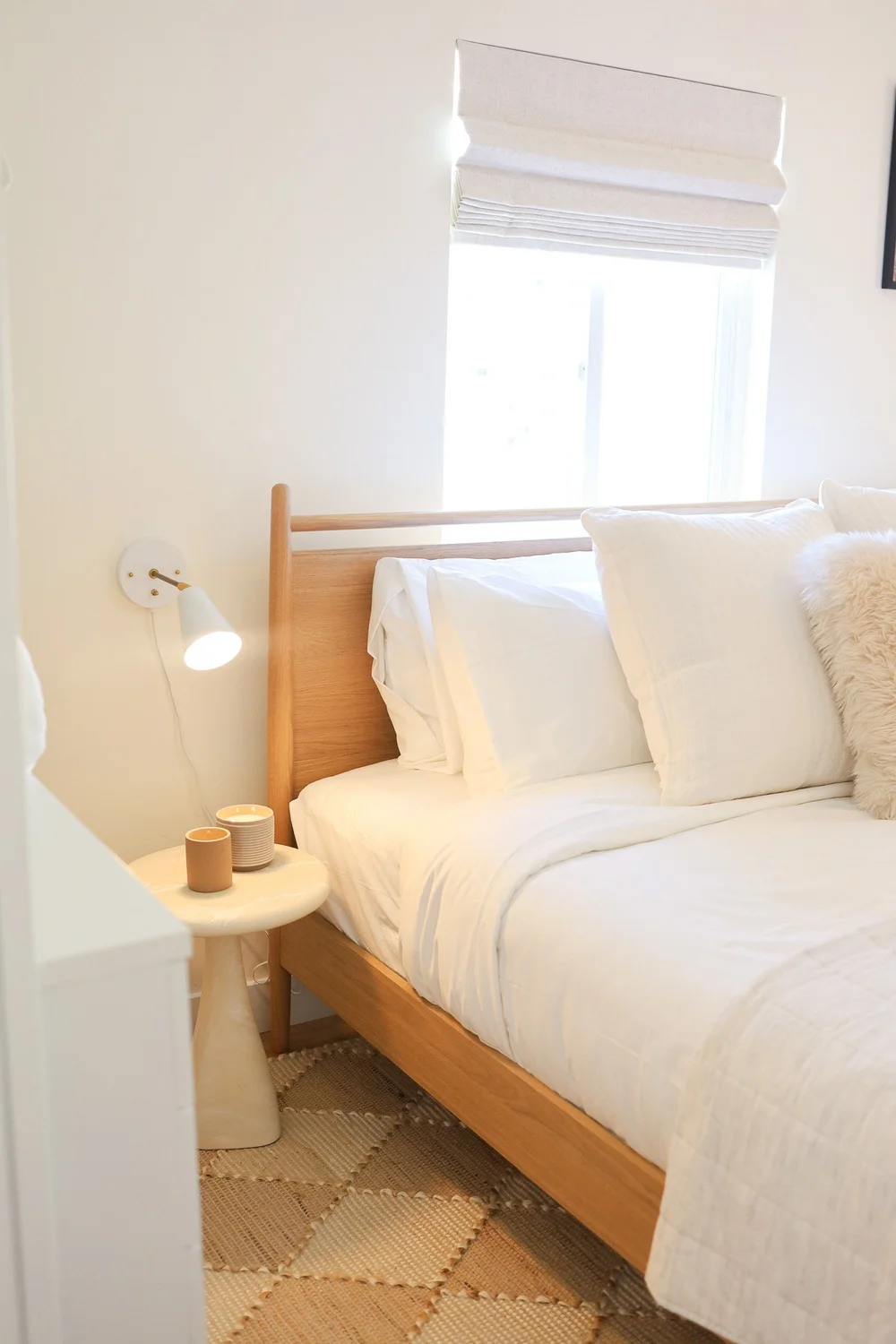 The king bed with a wood headboard in Unit Three at The Swell, Oceanside