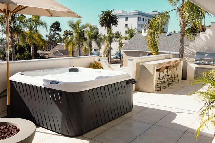 The shared hot tub at The Swell with palm trees behind