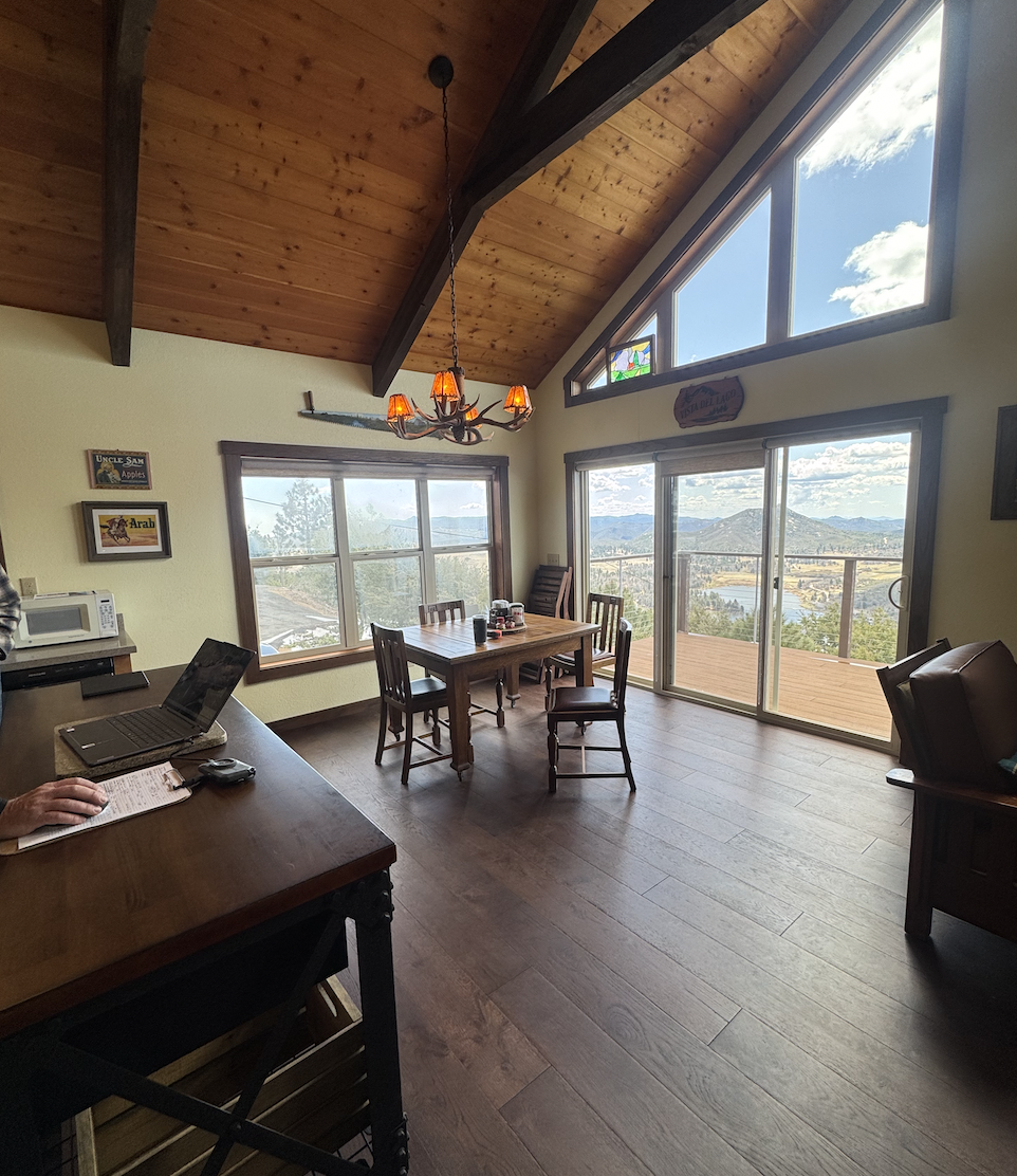 Before: dining area under the vaulted wood ceiling, sparsely furnished