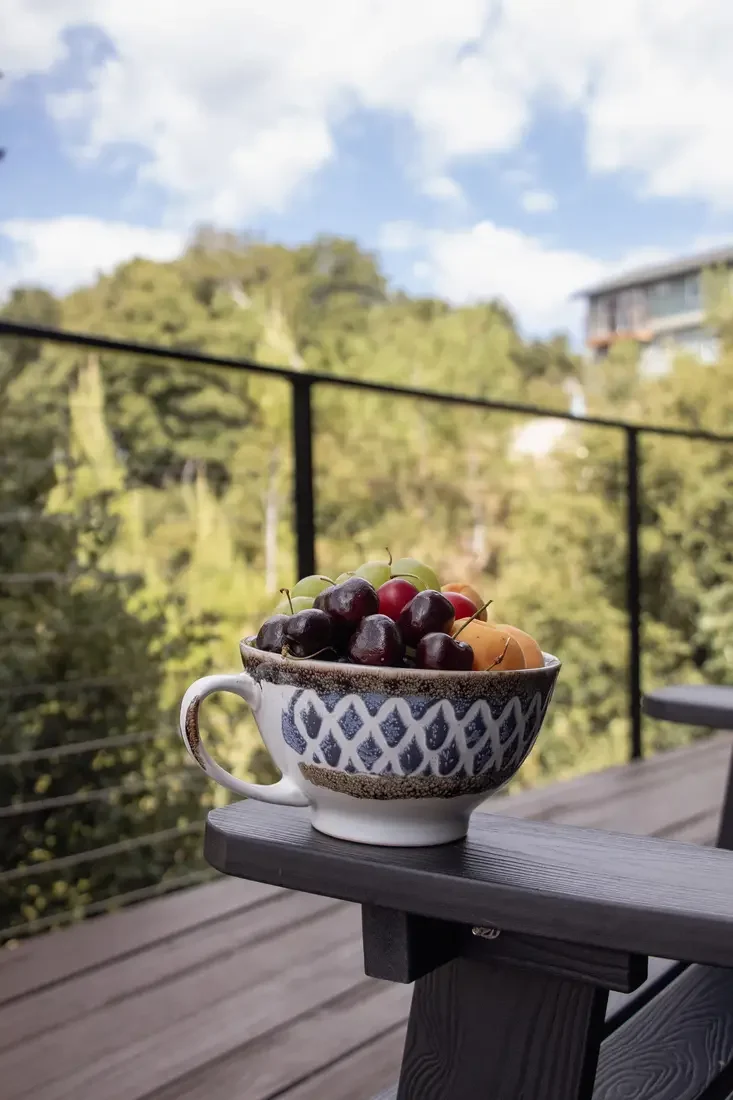 Guest photo: a bowl of fresh cherries on the deck railing