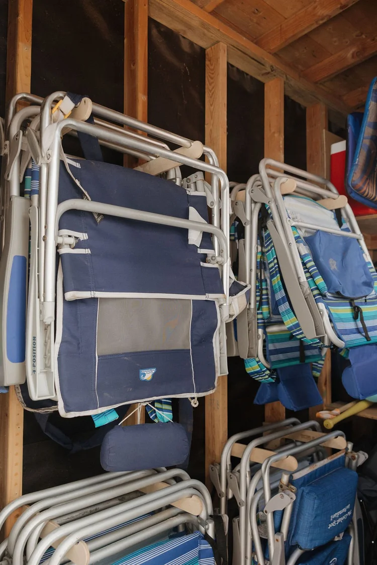 Striped beach chairs hanging in the beach shed at Seaside Square