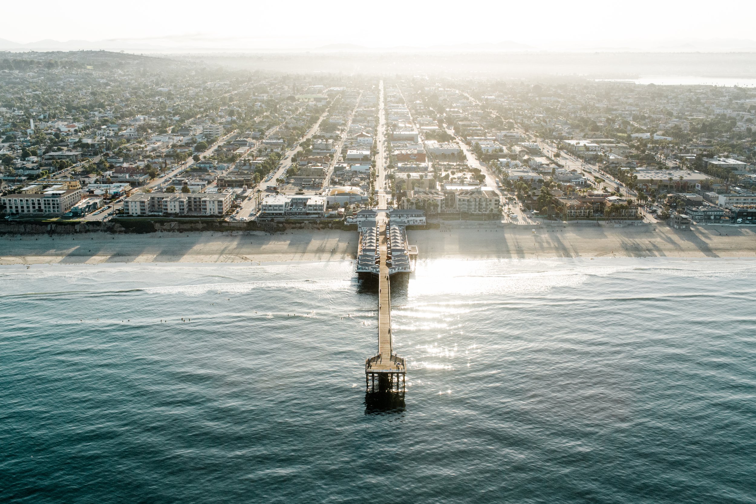 Crystal Pier reaching out from Pacific Beach into the ocean, seen from the air