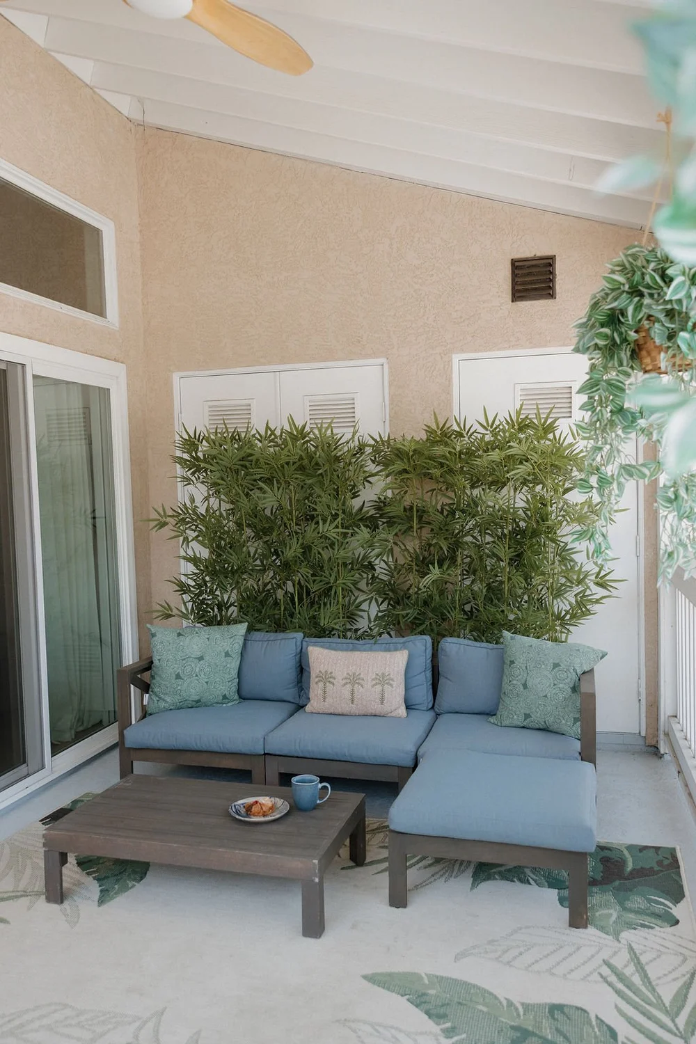 The private East Cove balcony with a blue outdoor sectional