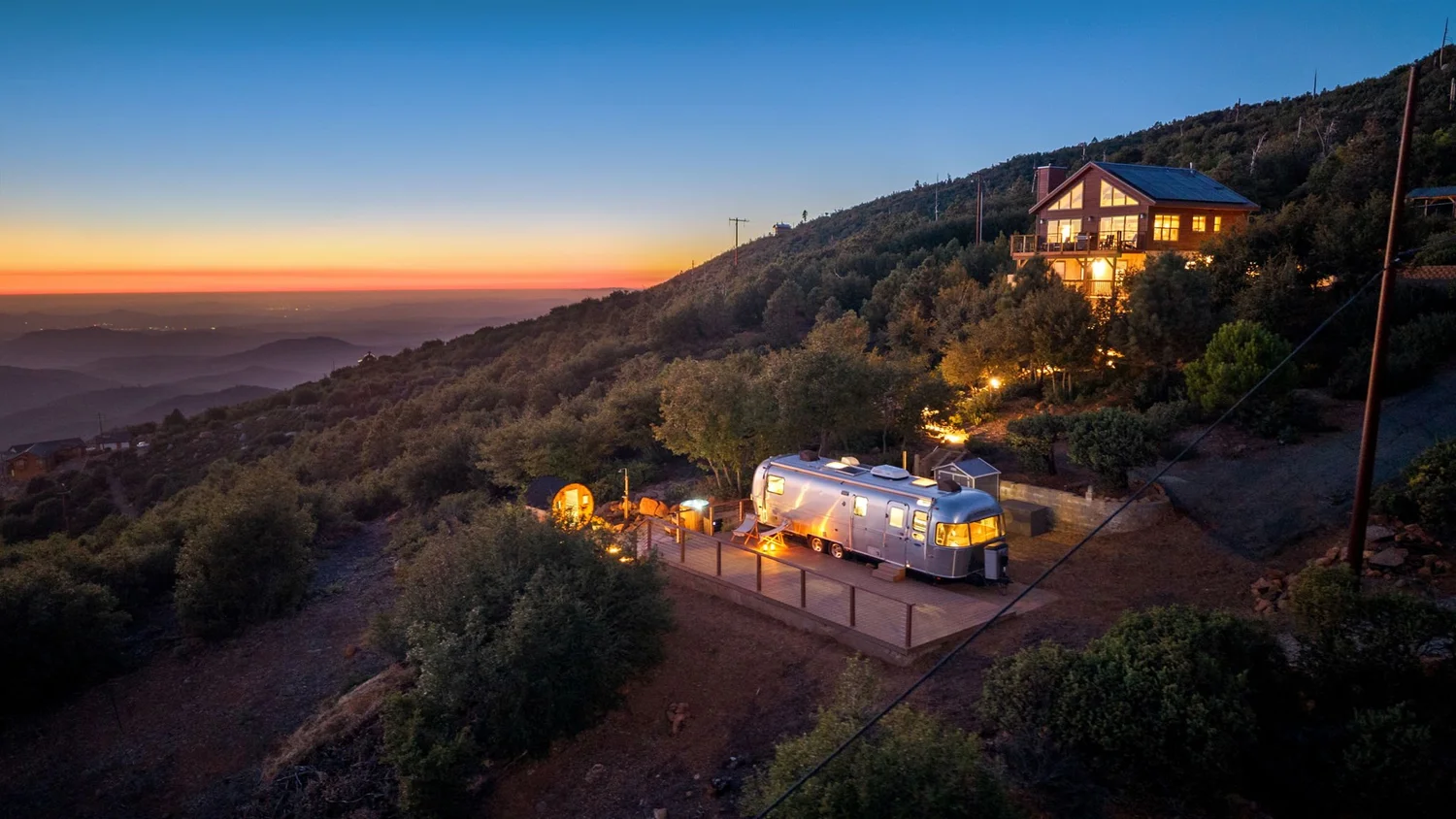 Airstream and wellness deck tucked into the mountains at sunset near Julian