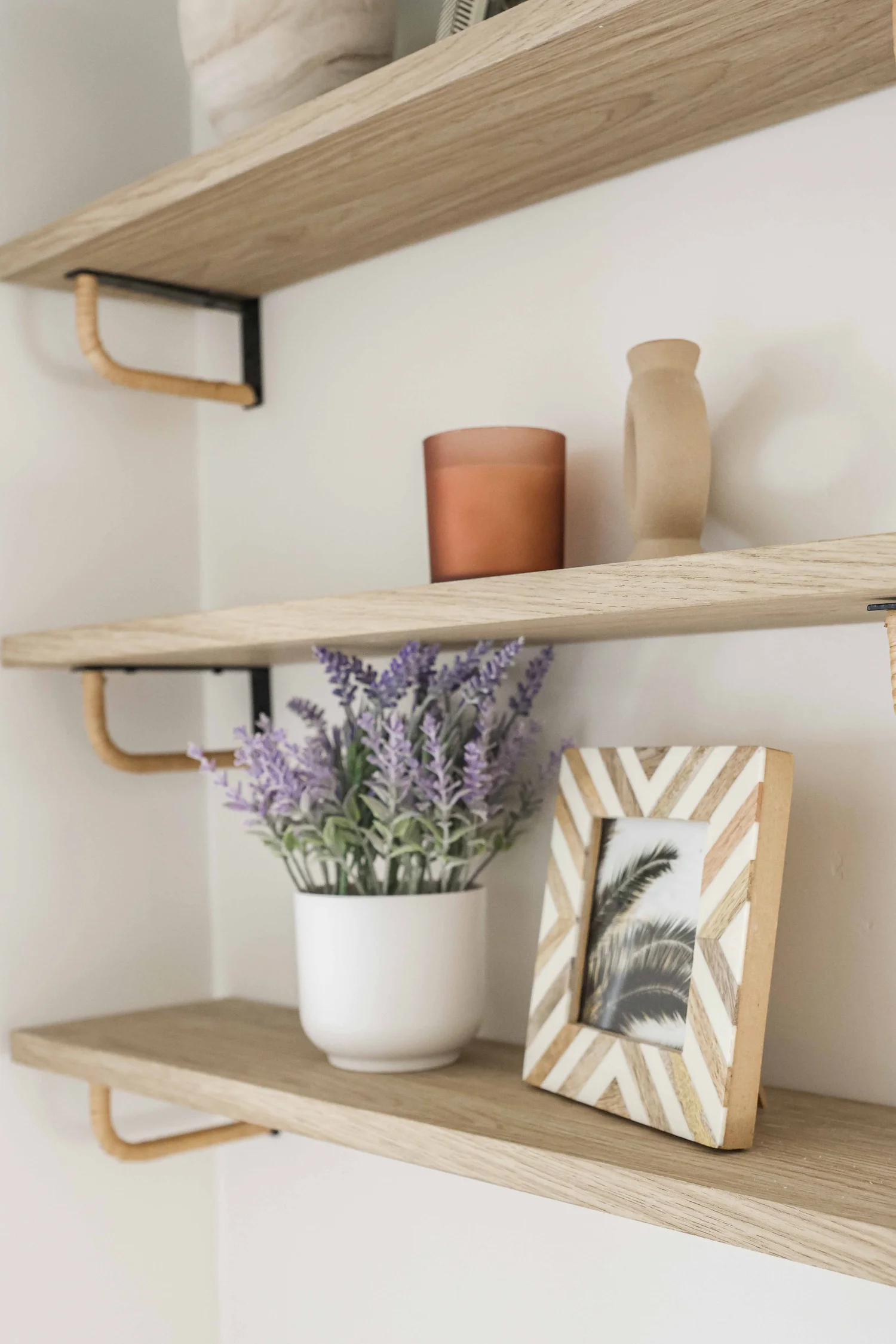 Open shelves with lavender and a framed photo at Clementine B in Oceanside, designed by Salt and Sky Lodging Co.
