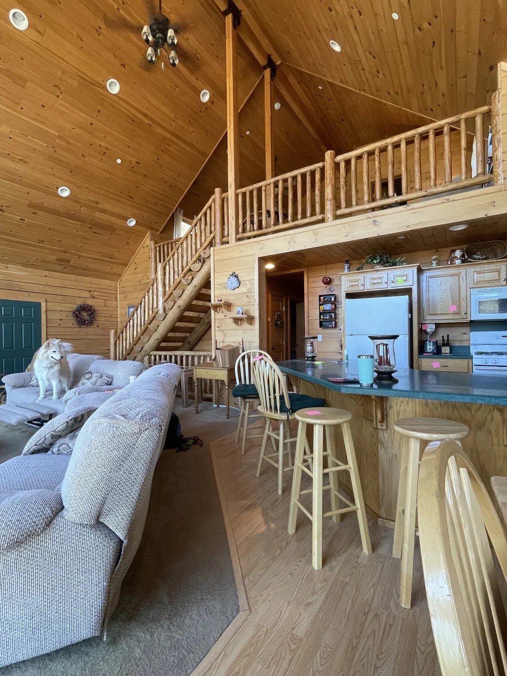 Before: Living room and kitchen bar under the loft at Dark Moon Chalet in Julian