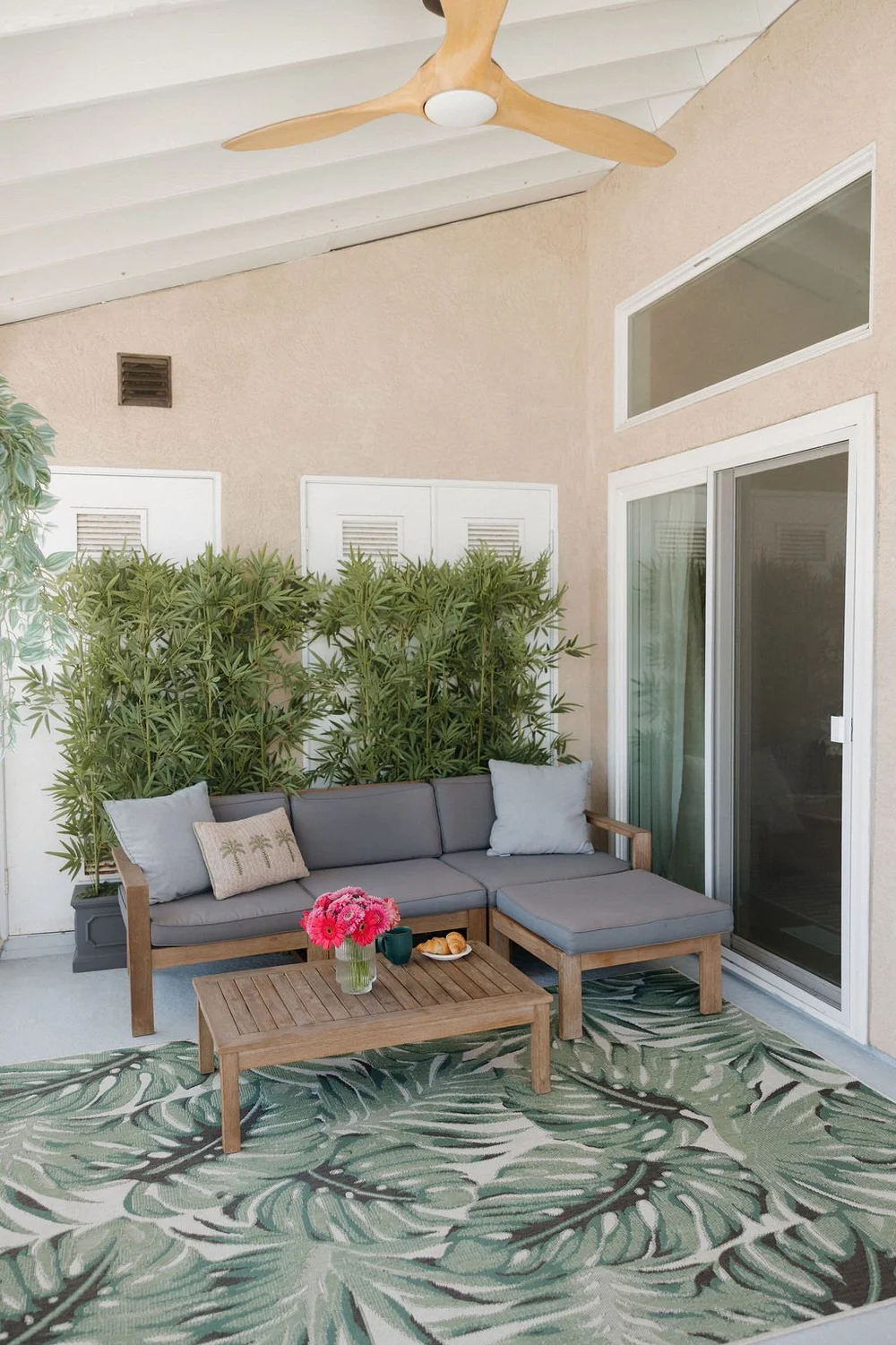 The private West Cove balcony with an outdoor sectional and bamboo