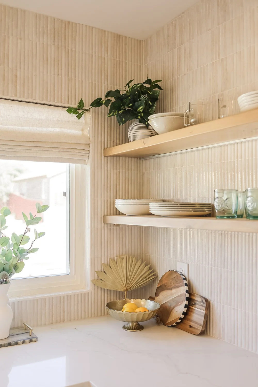 Open wood shelves with bowls and plants in Unit Three at The Swell, Oceanside
