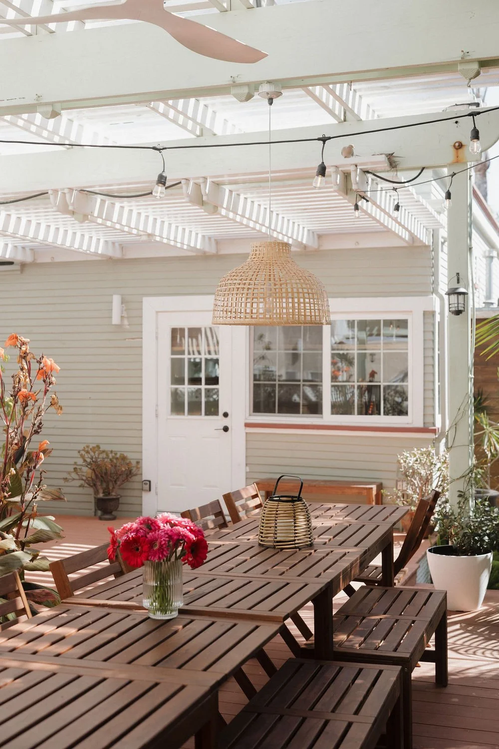 The shared courtyard at Seaside Square with a long table set with flowers under string lights
