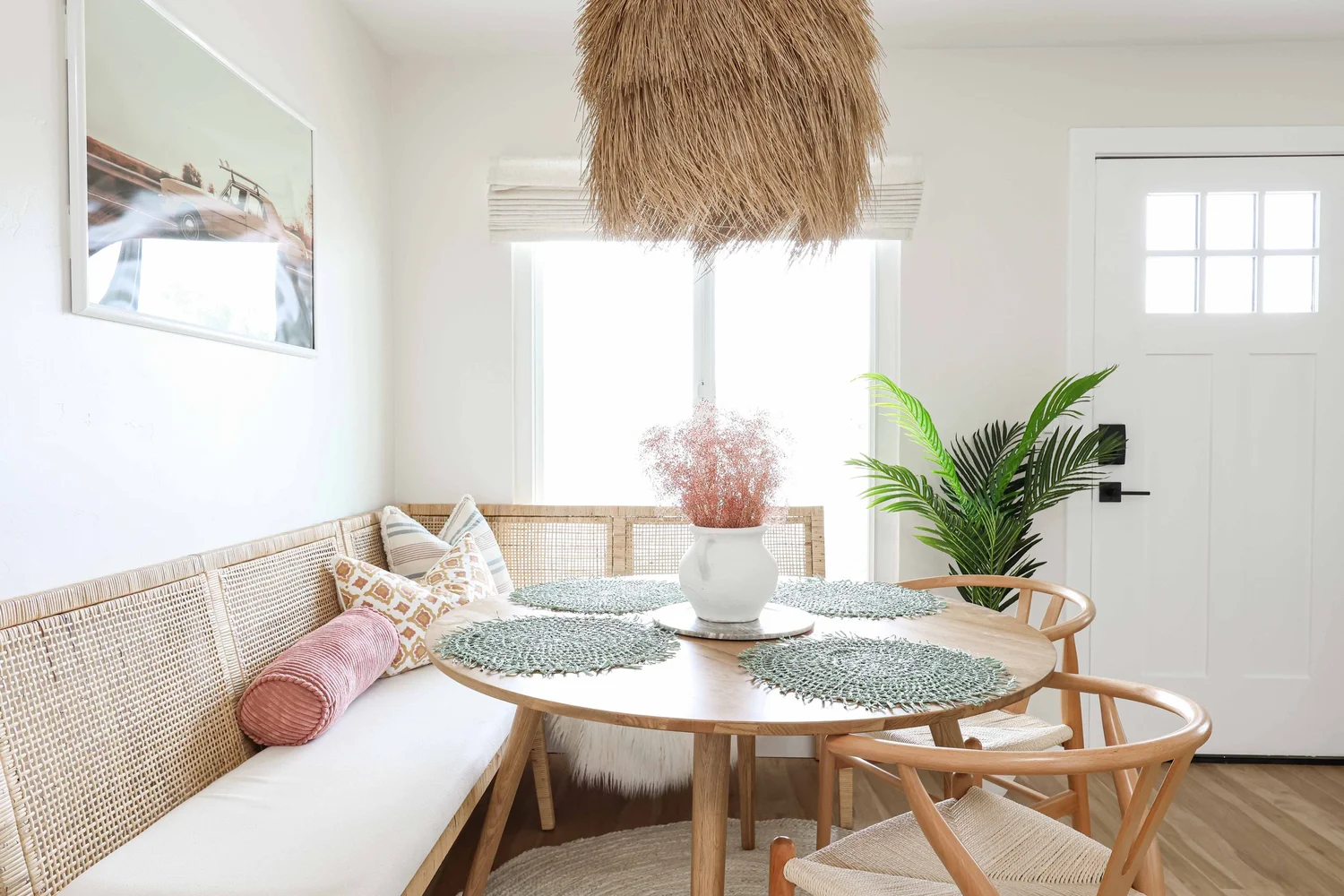 The dining nook in Unit One, with a seagrass pendant and a built-in bench
