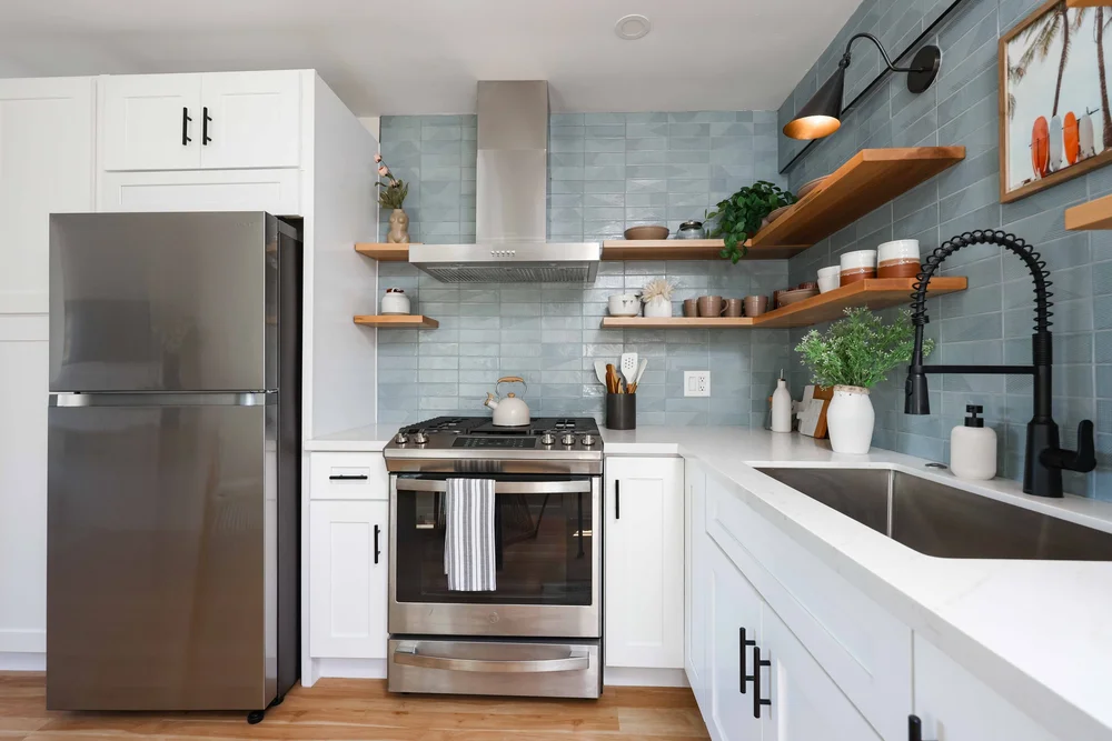 The stainless steel gas range and range hood in Unit Two at The Swell, Oceanside