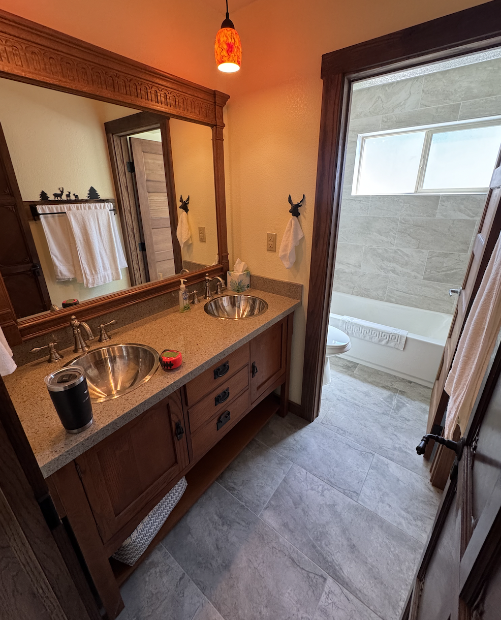 Before: bathroom with wood vanity and orange walls