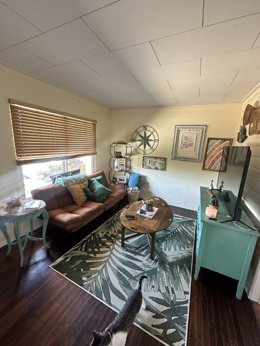 Before: Living room with a leather sofa at Clementine B in Oceanside