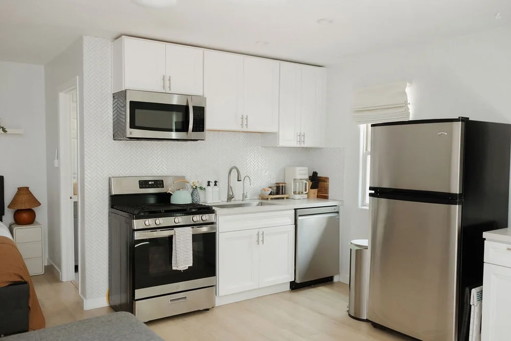 The full kitchen in The Sandbar studio with a gas range, dishwasher and full-size fridge