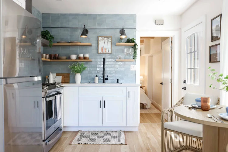 The kitchen with blue tile, open wood shelves and a gas range in Unit Two at The Swell, Oceanside