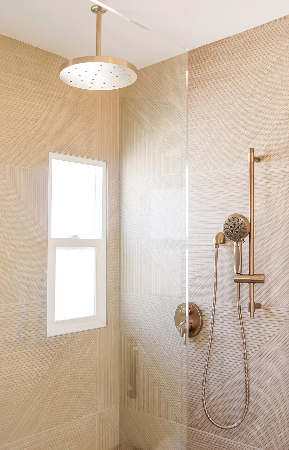 The shower with brass fixtures in Unit Three at The Swell, Oceanside