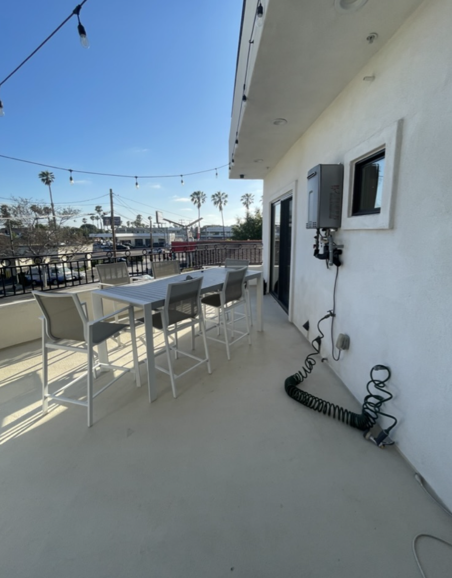 Before: Balcony with a plain patio table at Coastal Palm in Pacific Beach