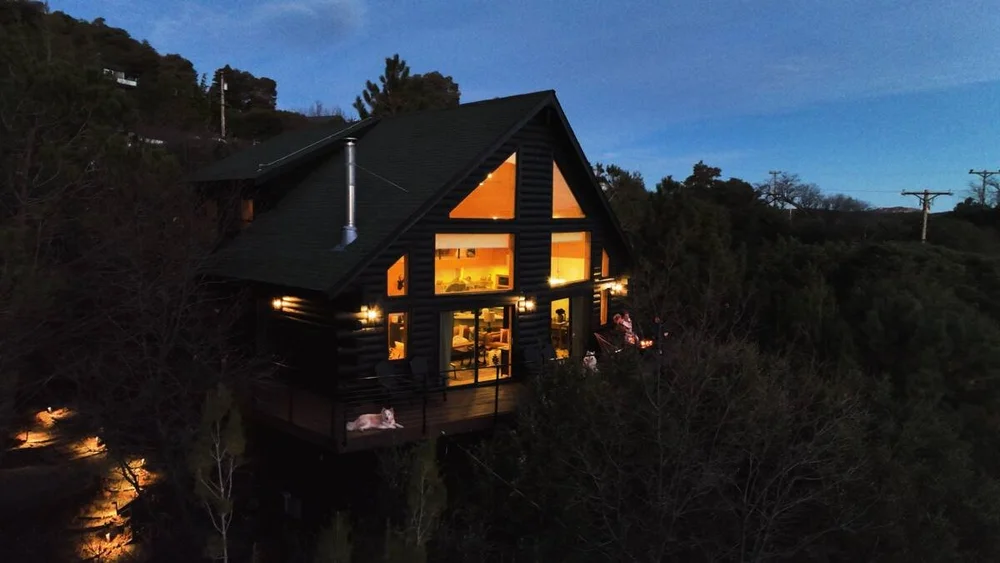 A-frame log cabin exterior at dusk — Dark Moon Chalet, Julian CA