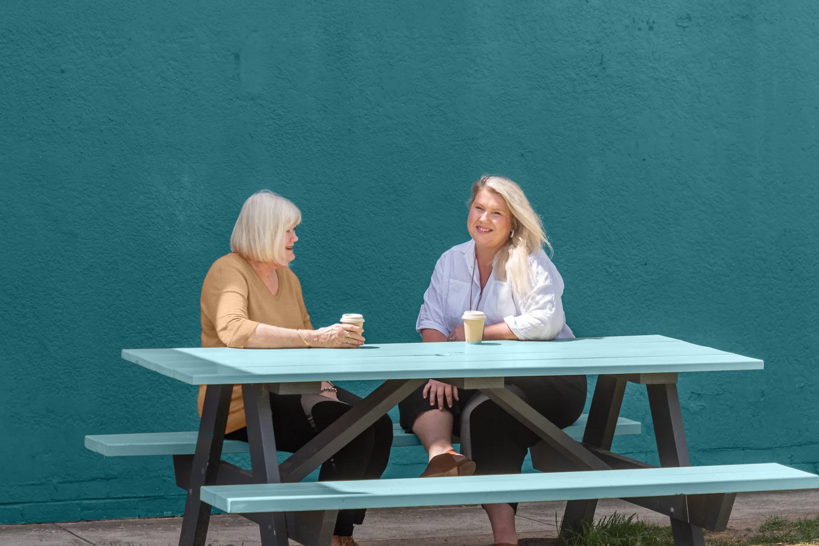 2 Lady's sitting at outdoor table