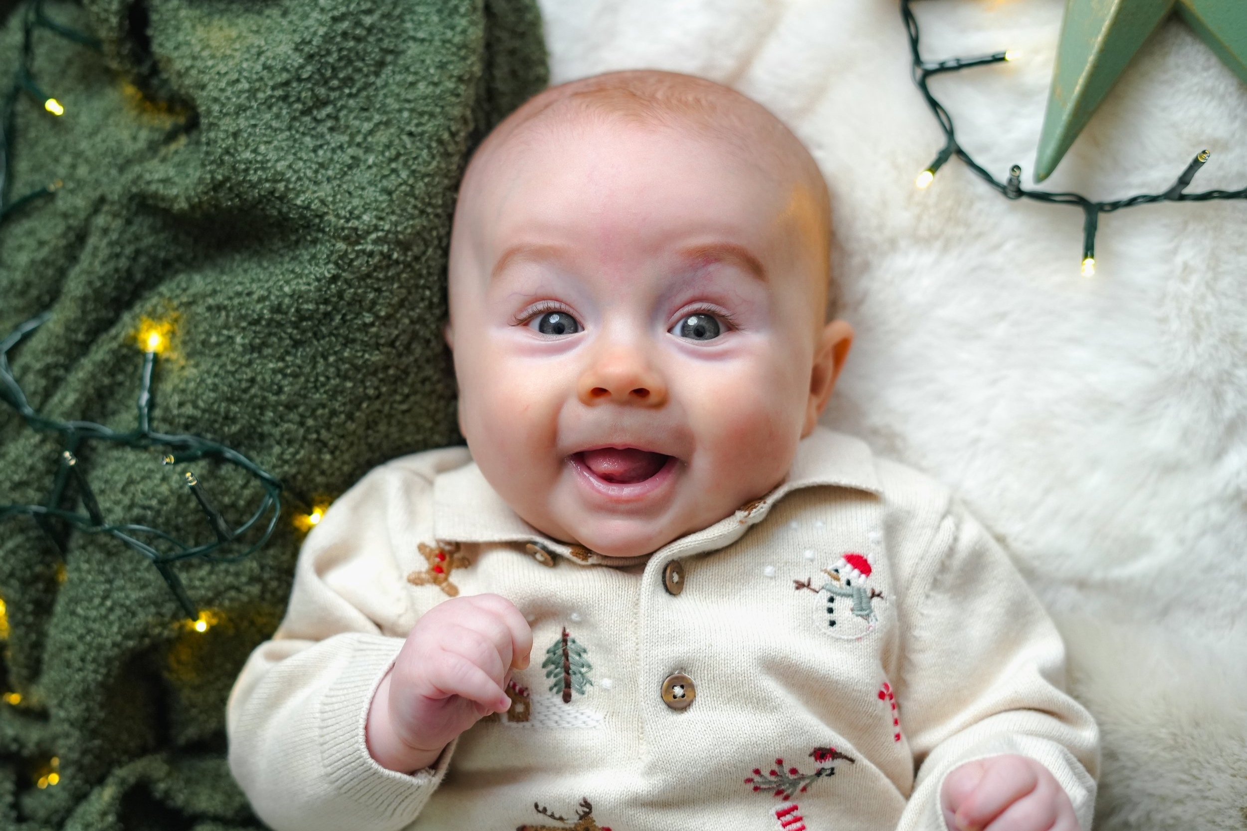 A baby smiling in a Christmas photoshoot in Neath United Kingdom