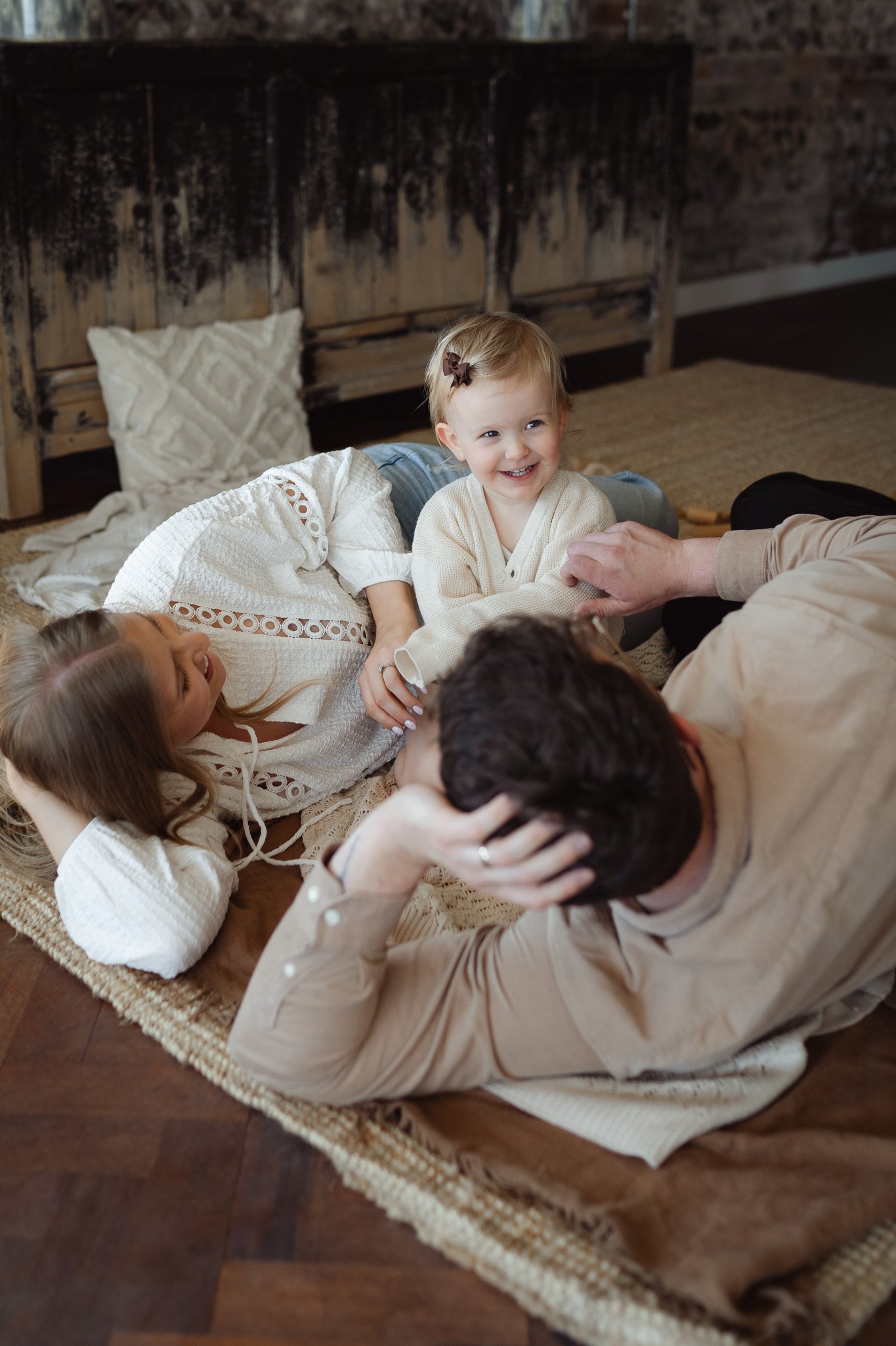 A natural moment of a family of 3 caught on camera in a family photoshoot South Wales